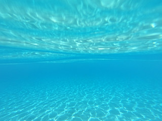 Underwater photo of mediterranean paradise island sandy beach with turquoise clear sea