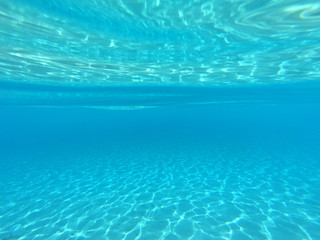 Underwater photo of mediterranean paradise island sandy beach with turquoise clear sea