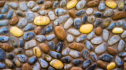 Bright summer sea pebble stones on the beach near ocean texture background