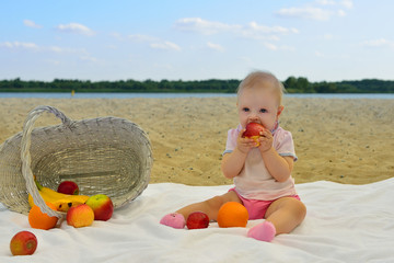 Girl eating fruit on the beach