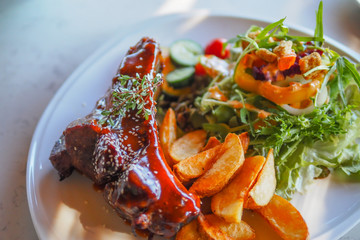 Closeup of pork ribs grilled with BBQ sauce and caramelized in honey.