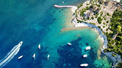 Fototapeta na wymiar Aerial drone bird's eye view photo of sail boats docked in tropical caribbean paradise bay with white rock caves and turquoise clear sea