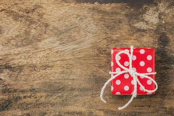 Red gift box on wood texture