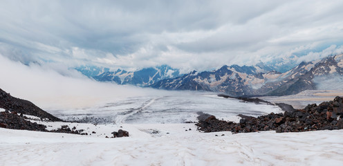 Fototapeta na wymiar Snow and ice landscape in Caucasus mountains in cloudly weather