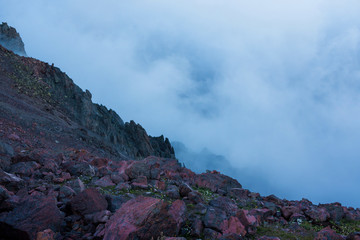 Mistic evening foggy landscape of wild nature in the mountains. Red stones. alien landscape