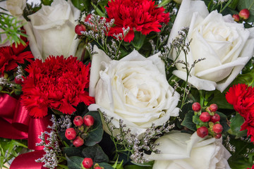 Close up group of red, white and pink flowers and leaves in colorful tone.