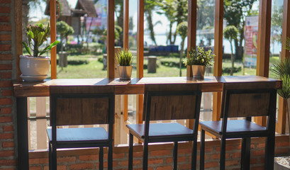 A flower vase placed on a table in a coffee shop on a chill day