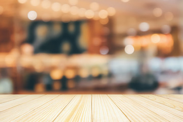 Cafe Restaurant interior with customer and wood table blur abstract background with bokeh light for montage product display