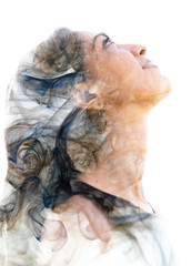 Double exposure portrait of a young exotic woman and a smoky texture dissolving into her facial features