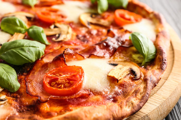 Delicious pizza with basil and cherry tomatoes, closeup