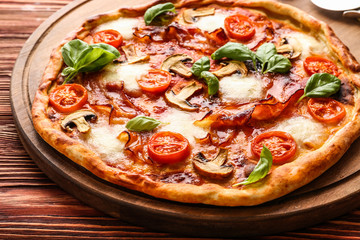 Delicious pizza on wooden board, closeup