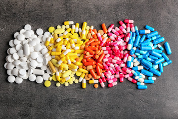 Different pills on grey background