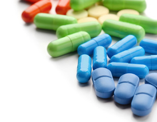 Colorful pills on white background