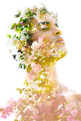 Double exposure of a young statuesque man’s portrait blended with pink and white flowers of a tree