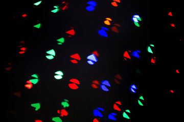 Fototapeta na wymiar Blurred view of beautiful lights on dark background