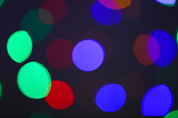 Blurred view of beautiful lights on dark background