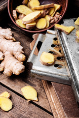 Fresh ginger on rustic background