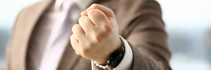Fototapeta premium Male clenched fist in suit at office