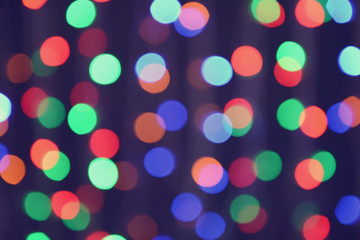 Blurred view of beautiful lights on dark background