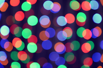 Blurred view of beautiful lights on dark background