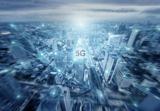 Technology 5G internet network illustration drawing onto aereal view of city skyline in light blue tone.