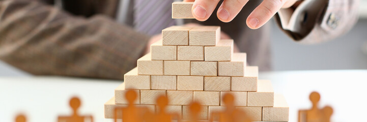 Obraz premium Male hand holds wood block of stair finish next