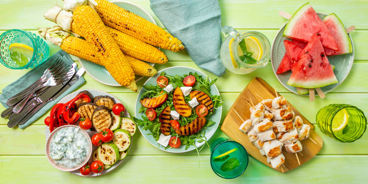 Summer bbq party concept - grilled chicken, vegetables, corn, salad, top view, copy space