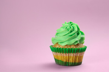 Tasty cupcake on color background