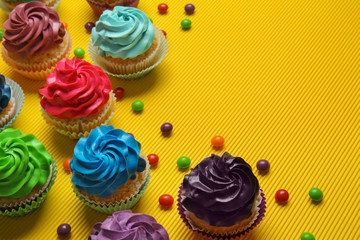 Different cupcakes on color background