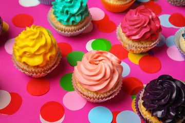 Different cupcakes on color background