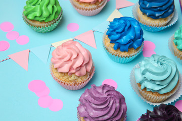 Different cupcakes on color background