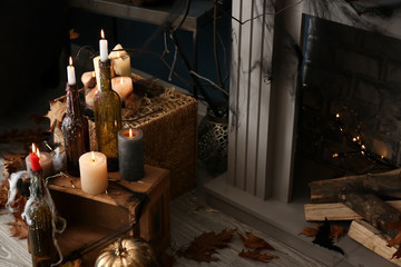 Burning candles as decor for Halloween party in room