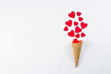 Ice Cream or Cone with Red Hearts on white Background. Top View. Love or Valentine's Day Concept. Top view, flat lay