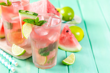 Watermelon lemonade with lime and mint, wood background, copy space