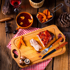 spicy roasted meat with mushroom sauce in the oven