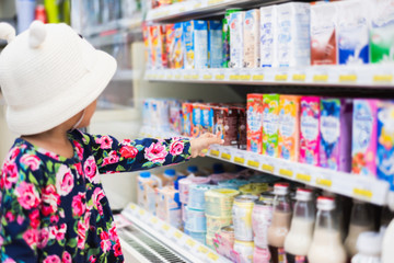Sweet Asian girl shopping in mini mart with basket, enjoy buying thing in mart