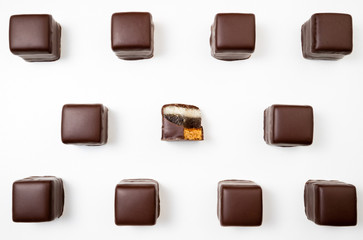 Pattern of chocolate candies. Chocolate pralines, truffles, marmalade, marzipan bonbons top view