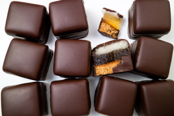 Background of chocolate candies. Chocolate pralines, truffles, marmalade, marzipan bonbons top view