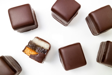 Pattern of chocolate candies. Chocolate pralines, truffles, marmalade, marzipan bonbons top view