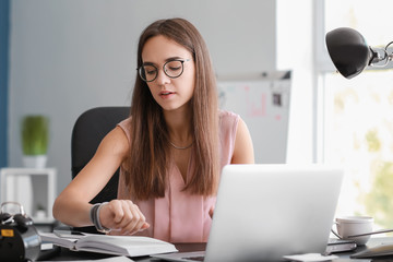 Young businesswoman trying to meet deadline in office