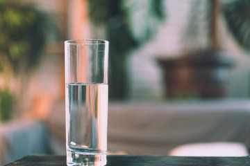 Glasses of water on a wooden table.