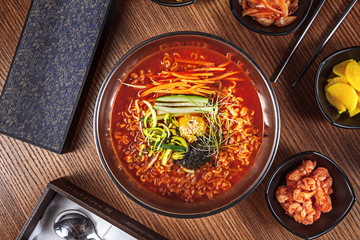 Top view ramen. Traditional Korean ramen soup with kimchi. Korean cuisine. Asian food. Traditional korean cuisine set. Picture for recipe. Copy space for text logo or brand.