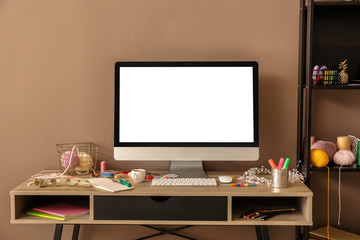 Modern workplace of designer near color wall