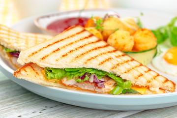 Club sandwich panini with ham, tomato, cheese and basil with cheese balls