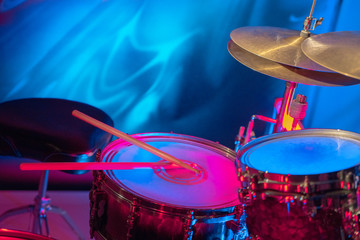 Fototapeta na wymiar Drum set in unusual color lighting