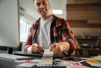 Young designer working in office