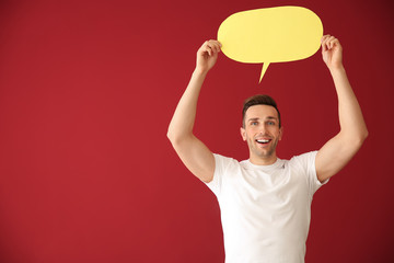 Young man with speech bubble on color background