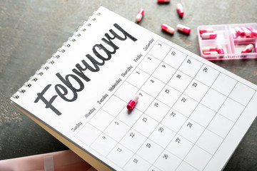 Menstrual calendar on grey table