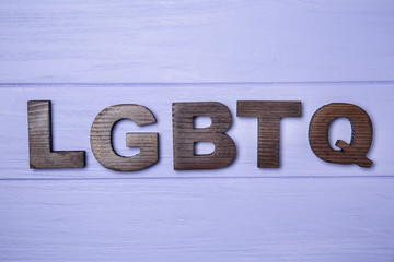 Abbreviation LGBTQ on wooden background