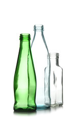 Used glass bottles on white background. Recycling concept